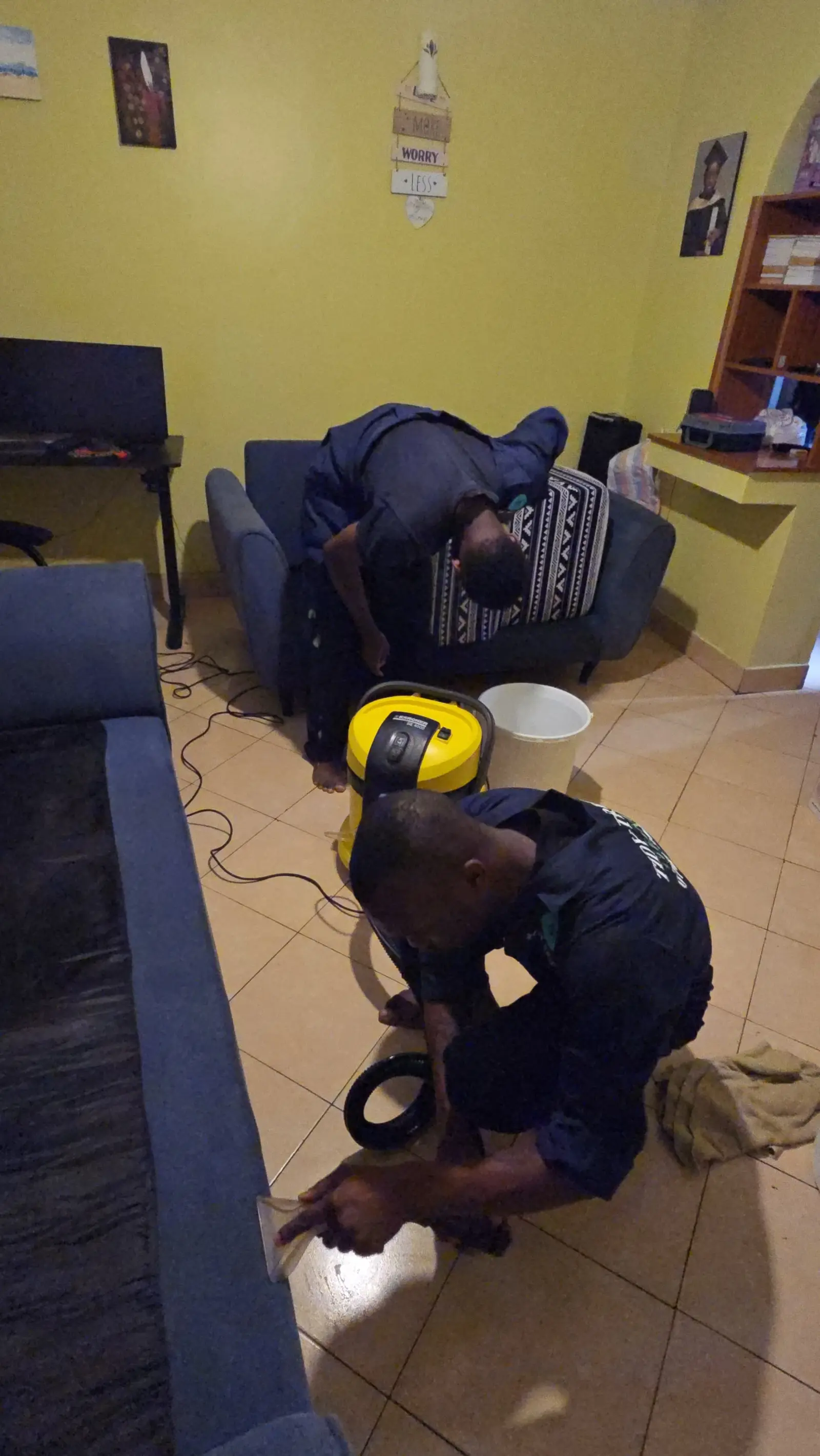 Extractor pulling dirt out of a fabric sofa seat