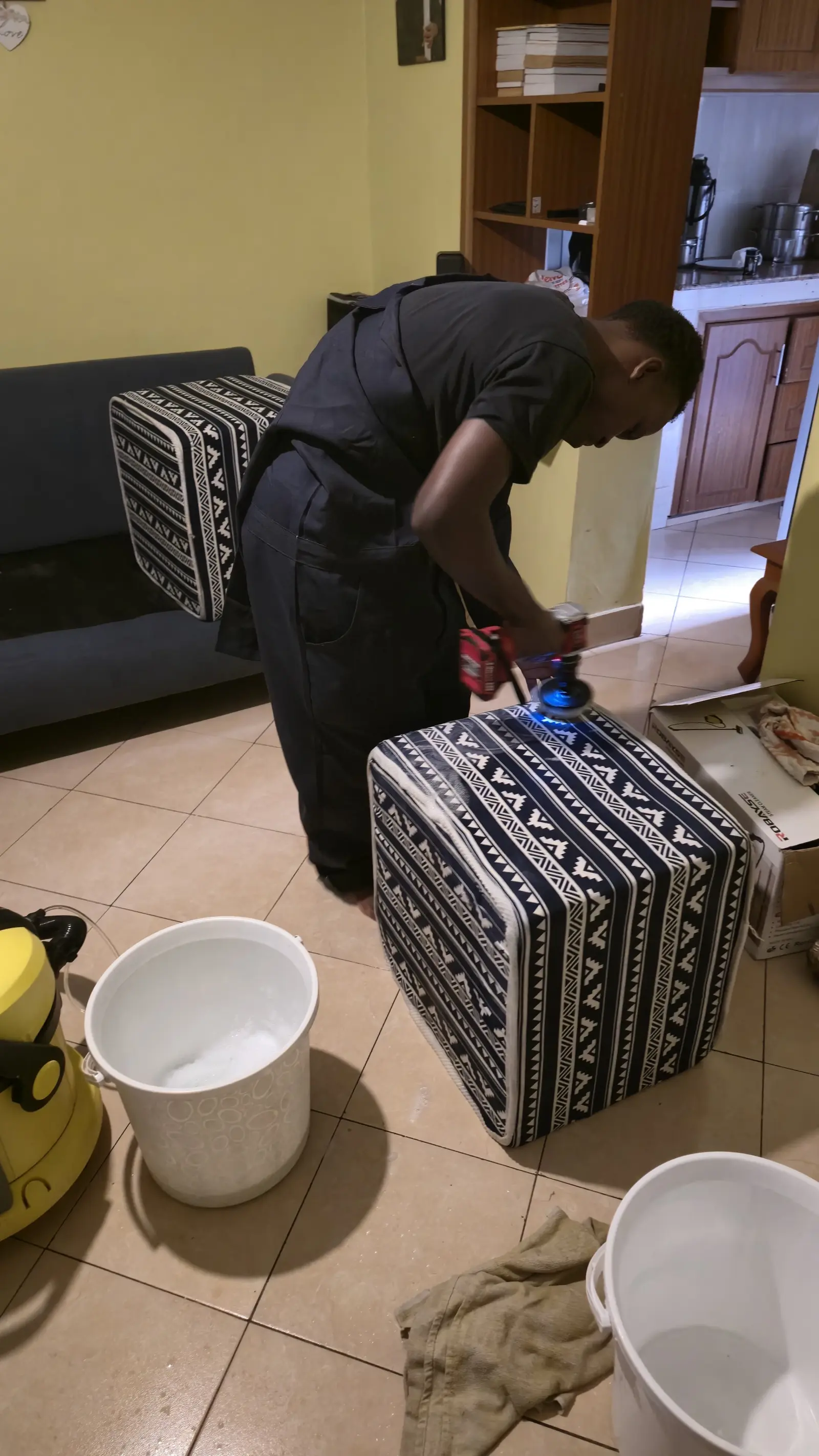 Patterned ottoman being scrubbed and rinsed